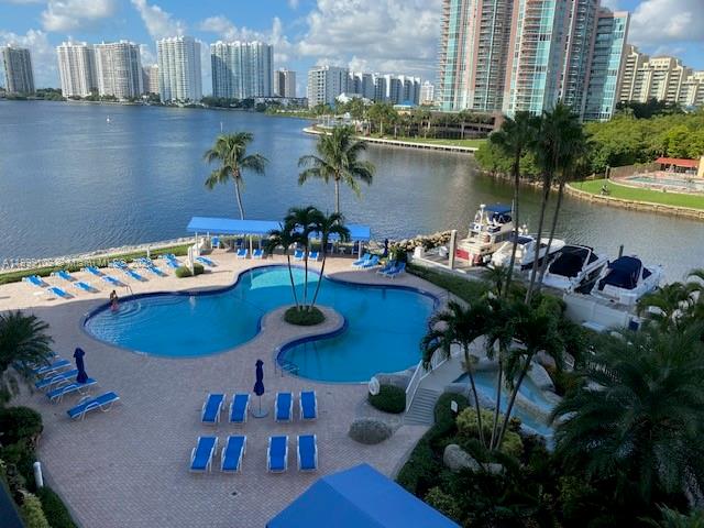 3530 Mystic Pointe Drive, Unit 2503 Aventura, FL 33180 - Photo 19 of 24 a view of a swimming pool with outdoor seating
