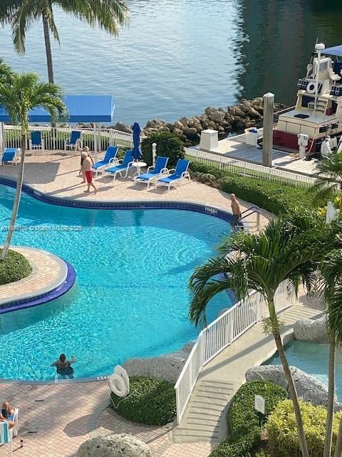 3530 Mystic Pointe Drive, Unit 2503 Aventura, FL 33180 - Photo 22 of 24 a view of a backyard with plants and lake view