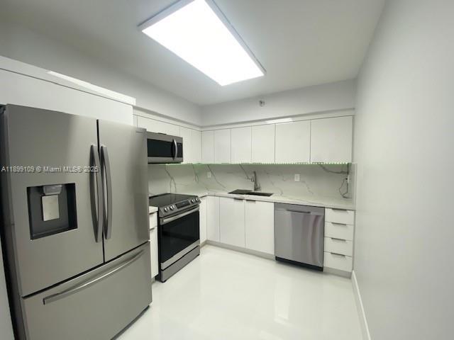 3530 Mystic Pointe Drive, Unit 2503 Aventura, FL 33180 - Photo 9 of 24 a kitchen with stainless steel appliances granite countertop a refrigerator and a stove