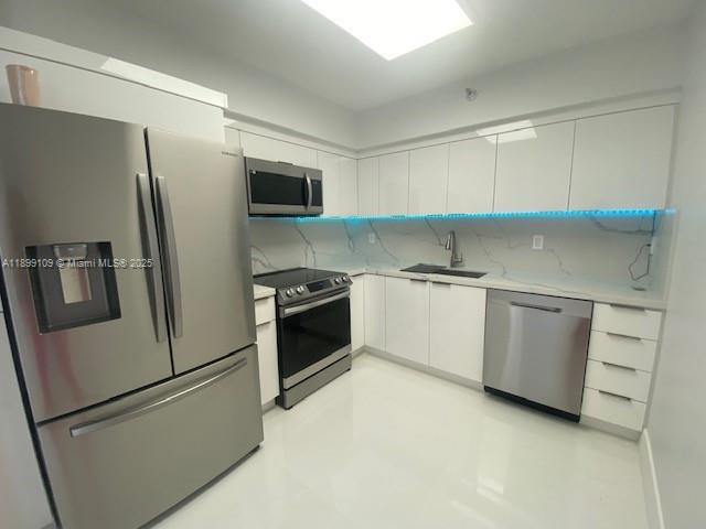 3530 Mystic Pointe Drive, Unit 2503 Aventura, FL 33180 - Photo 10 of 24 a kitchen with a refrigerator stove and a sink