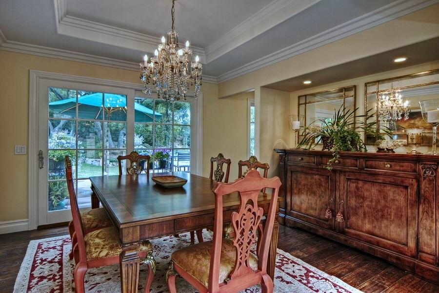 908 El Rancho Road Santa Barbara, CA 93108 - Photo 4 of 9 a dining room with furniture a rug and a chandelier