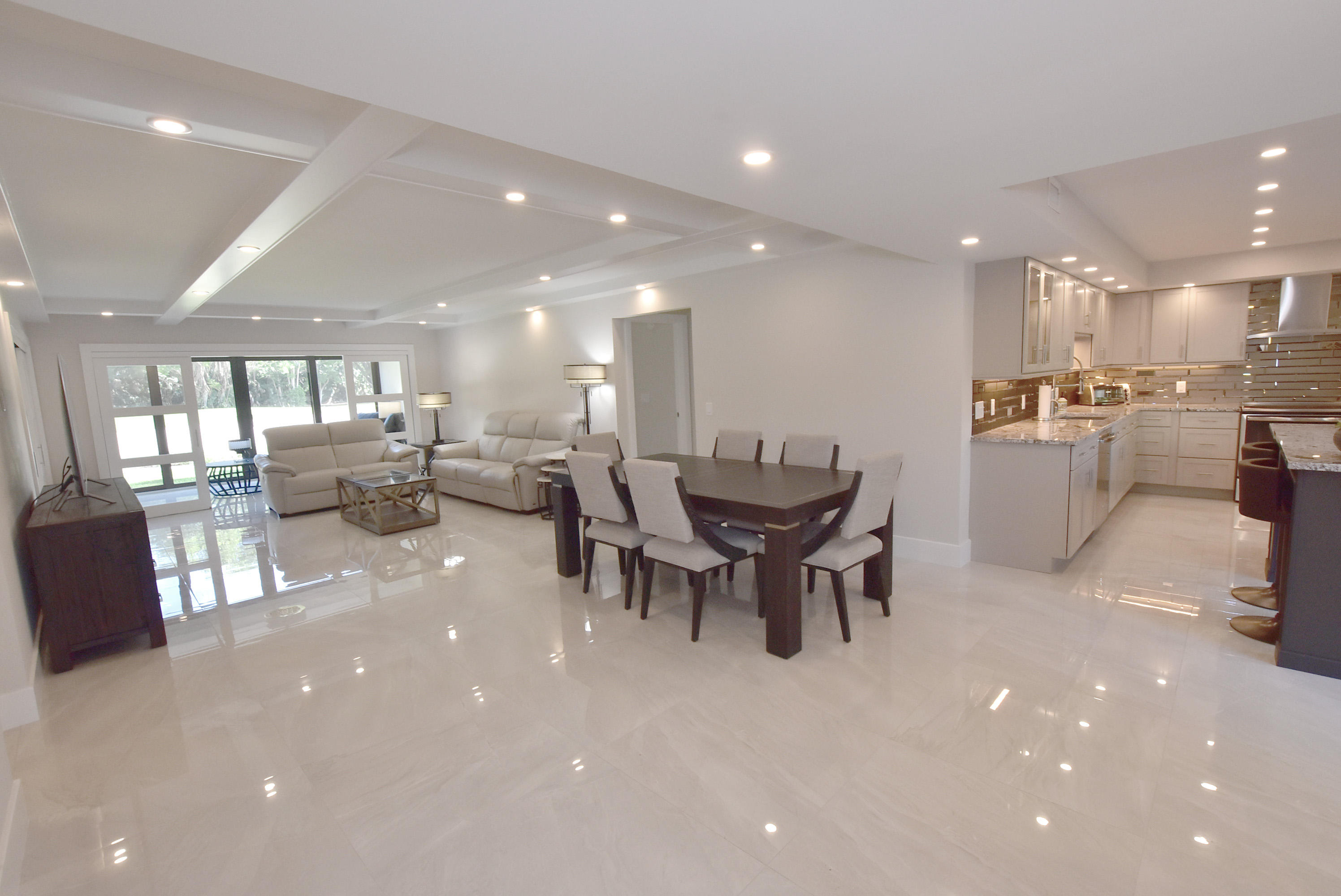 a kitchen with a dining table chairs and stainless steel appliances