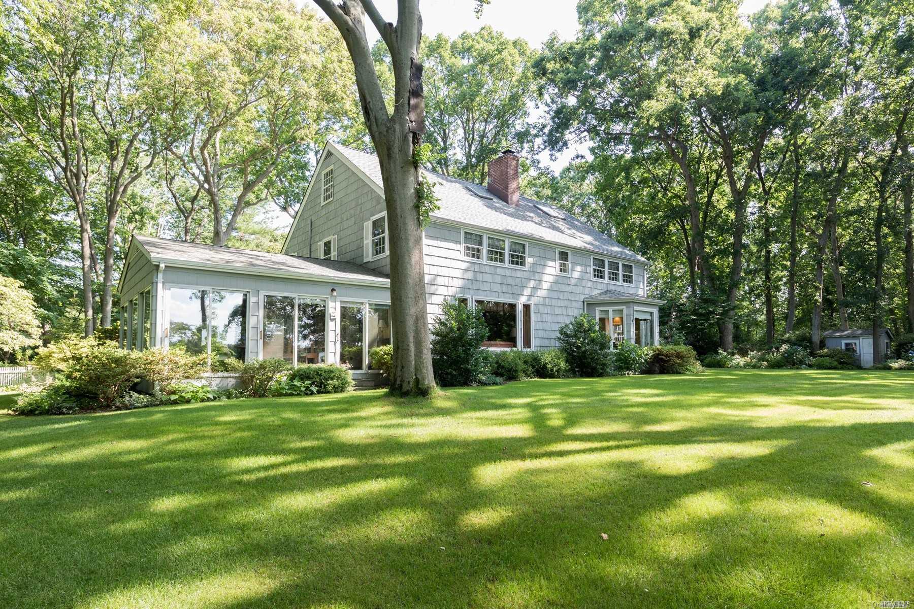 118 Jennings Road Cold Spring Harbor, NY 11724 - Photo 1 of 1 a front view of a house with a garden