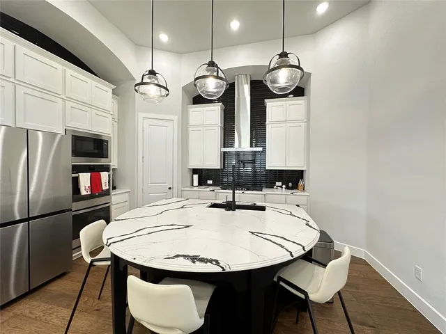 a view of a dining area with furniture and kitchen view