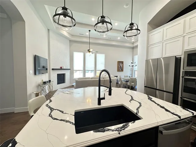 a kitchen with stainless steel appliances a sink a microwave a stove and refrigerator