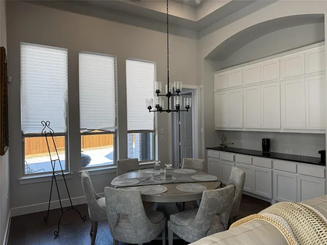 a kitchen with a sink and chairs