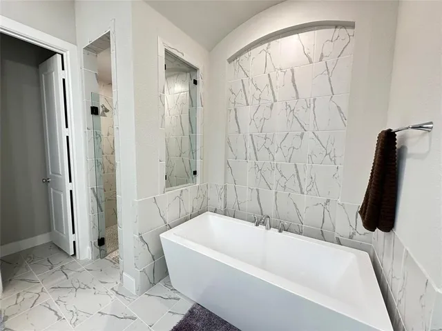 a bathroom with a tub and shower