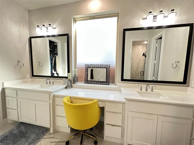 a bathroom with a double vanity sink and a mirror