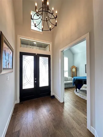 a view of a livingroom with wooden floor and a ceiling fan
