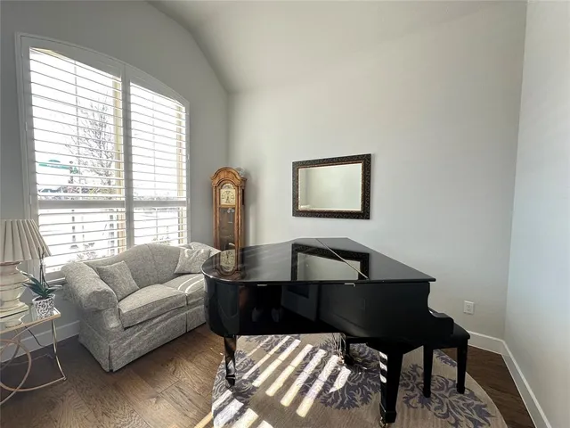 a living room with furniture and a lamp