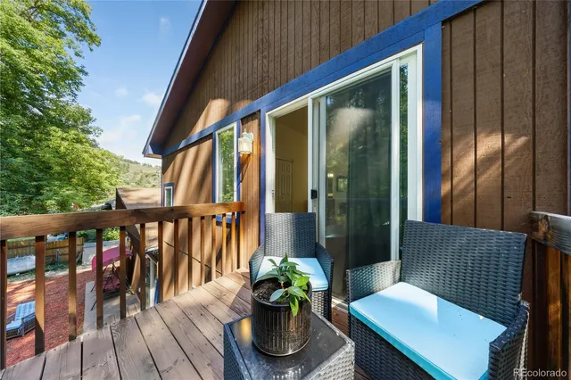 a view of a two chairs in the balcony