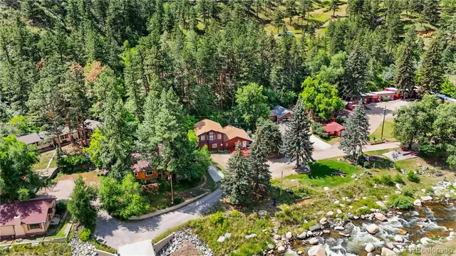 an aerial view of a house with a yard and garden