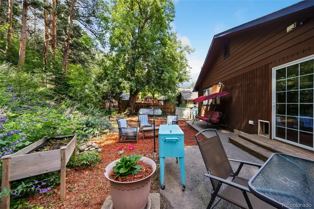 a view of backyard with outdoor seating and plants