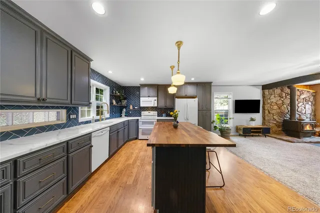 a open kitchen with cabinets a sink and appliances
