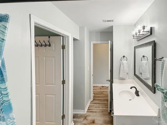 a bathroom with a sink a mirror and a shower