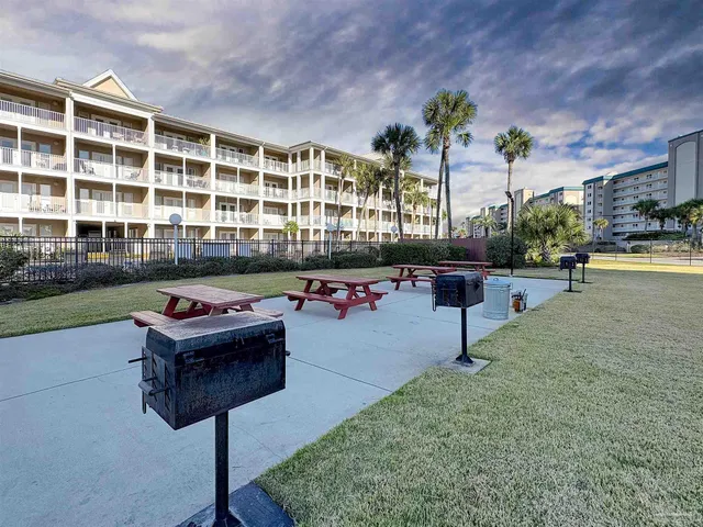 a swimming pool with outdoor seating and plants