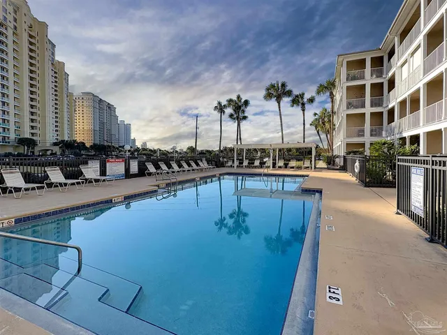 a view of a swimming pool with outdoor seating