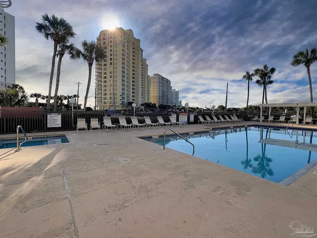 a view of swimming pool with outdoor seating