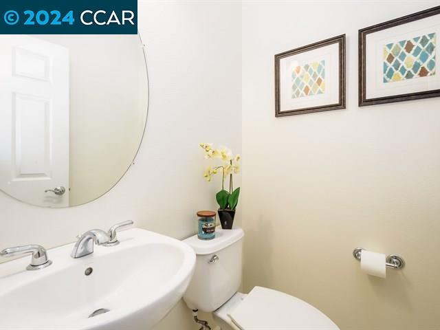 3666 Finnian Way Dublin, CA 94568 - Photo 10 of 17 a bathroom with a sink mirror and toilet