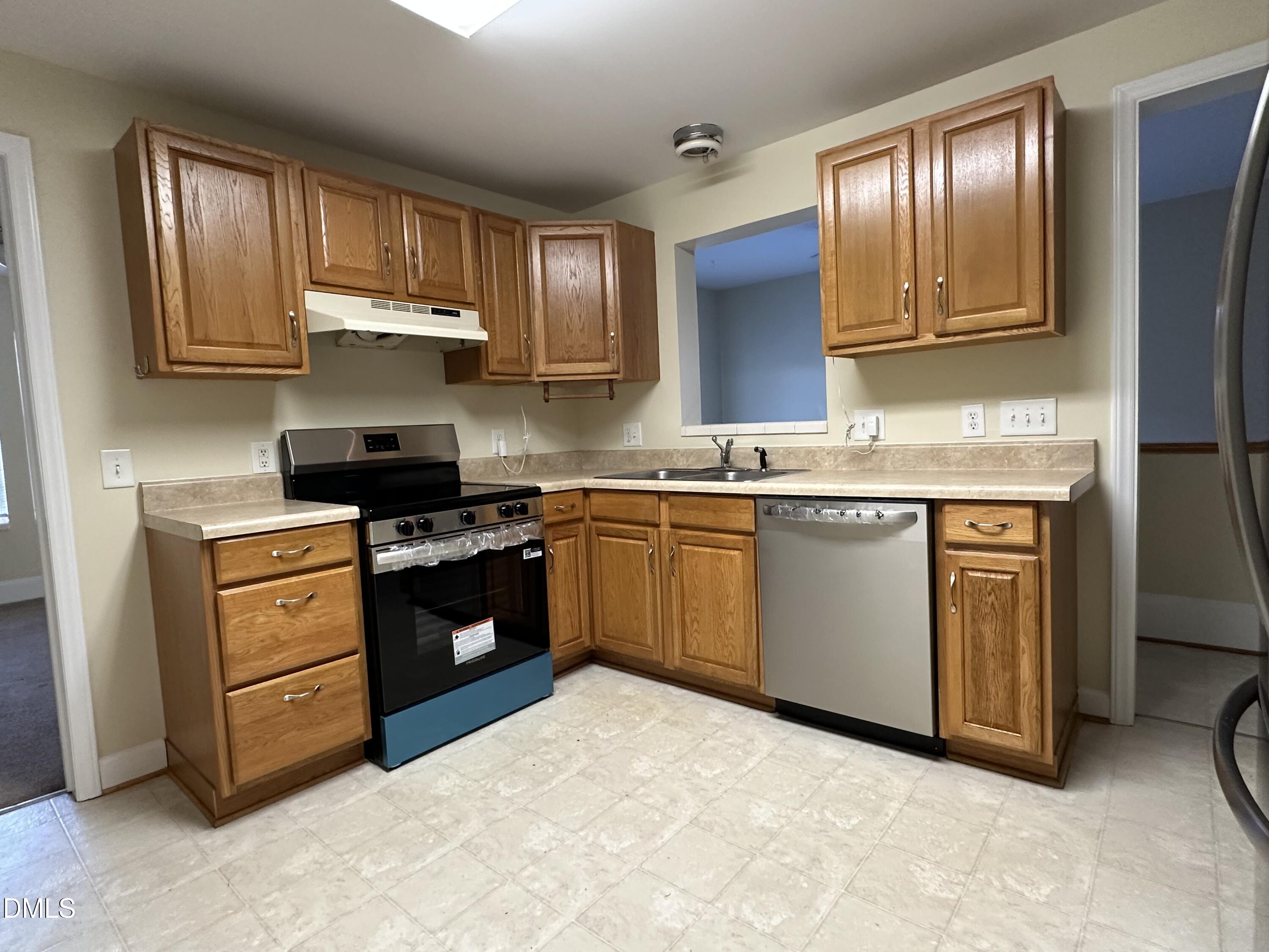 203 North 9th Street Mebane, NC 27302 - Photo 3 of 10 a kitchen with a stove top oven sink and cabinets