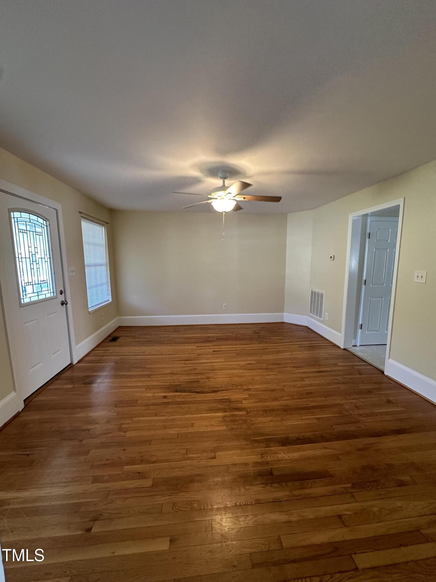 203 North 9th Street Mebane, NC 27302 - Photo 4 of 10 a view of a room with wooden floor and window
