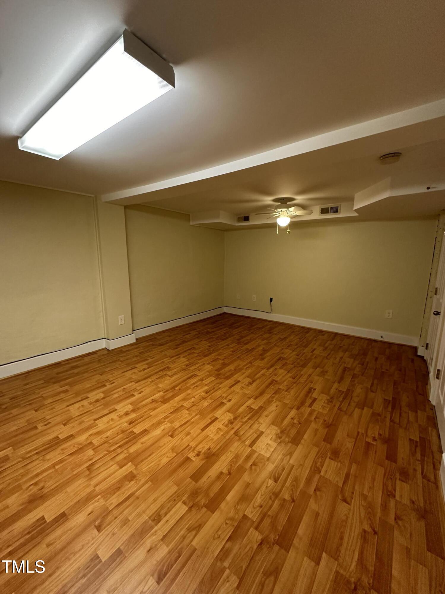 203 North 9th Street Mebane, NC 27302 - Photo 8 of 10 a view of empty room with wooden floor