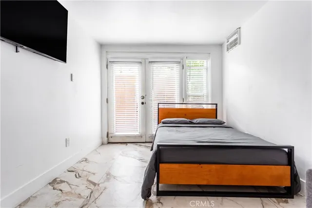 a bed sitting in a bedroom next to a window