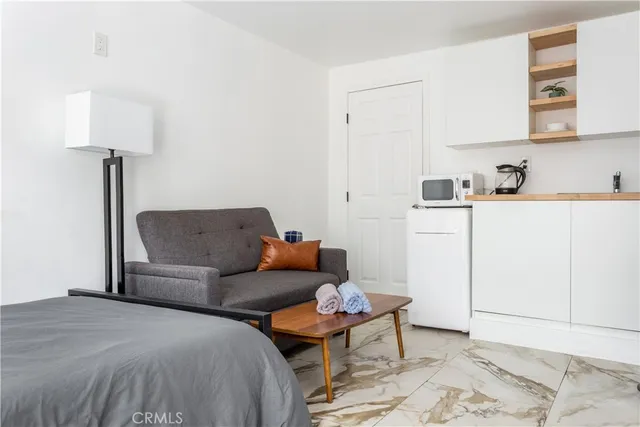 a living room with furniture and a lamp