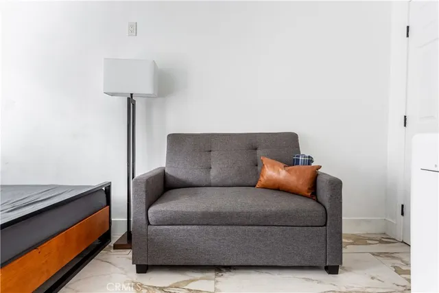 a living room with furniture and a lamp