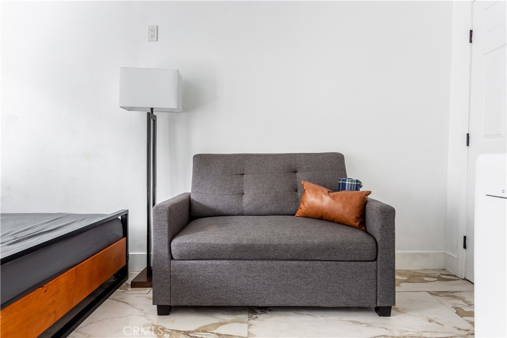 14818 Round Valley Drive, Unit C Sherman Oaks, CA 91403 - Photo 4 of 8 a living room with furniture and a lamp