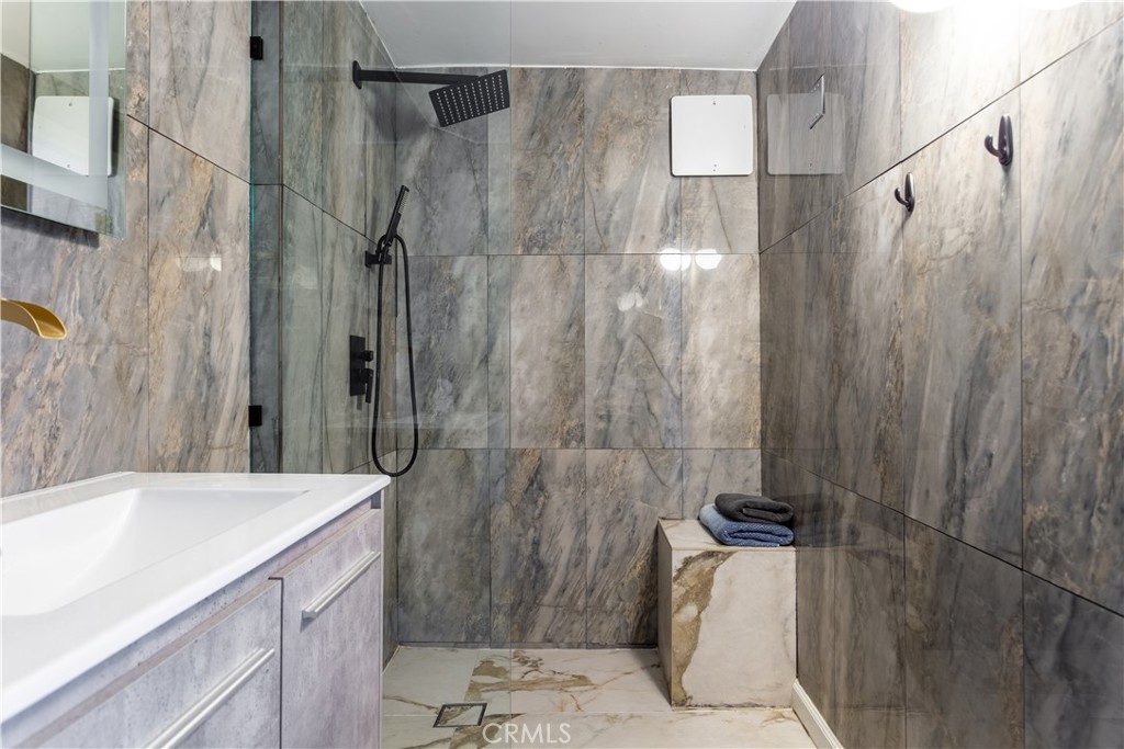 14818 Round Valley Drive, Unit C Sherman Oaks, CA 91403 - Photo 6 of 8 a bathroom with a sink and shower