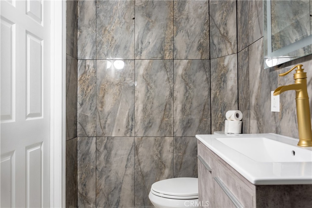 14818 Round Valley Drive, Unit C Sherman Oaks, CA 91403 - Photo 7 of 8 a bathroom with a sink a toilet and shower