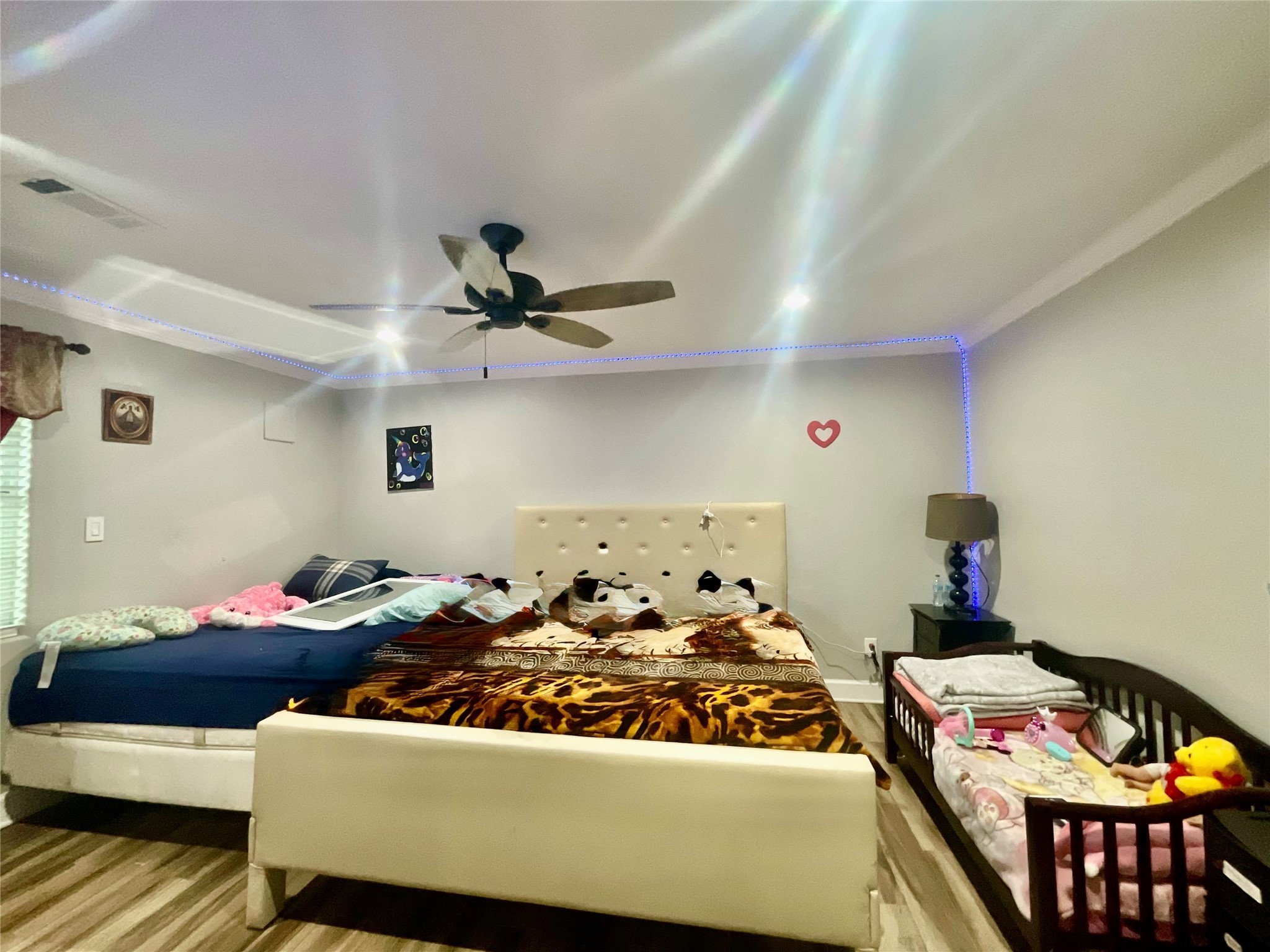 9213 Madera Road Houston, TX 77078 - Photo 13 of 15 a bedroom with a bed and a chandelier