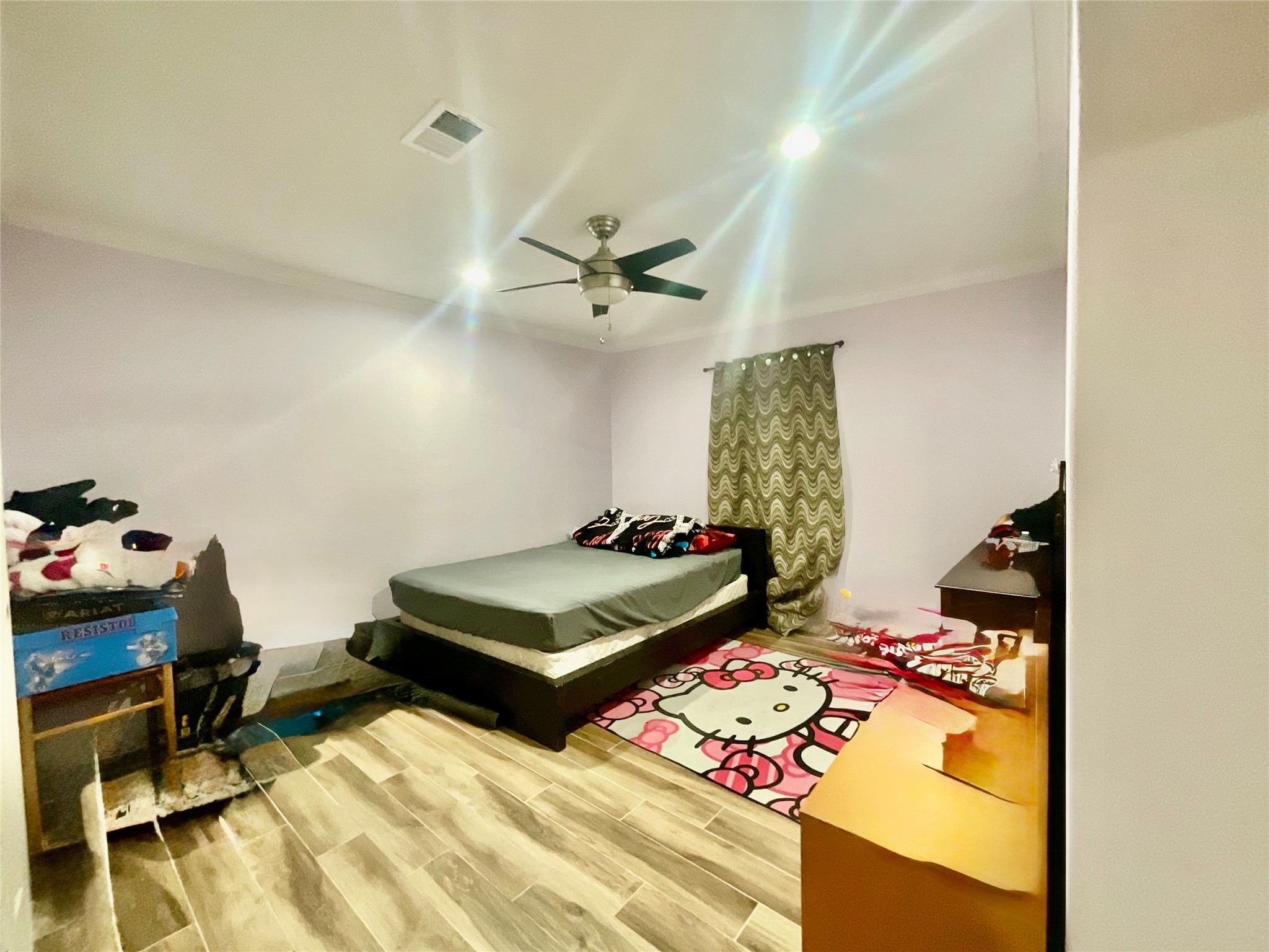 9213 Madera Road Houston, TX 77078 - Photo 9 of 15 a bedroom with a bed and a chandelier