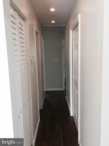 a view of a hallway with a wooden floor