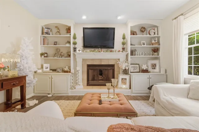 a living room with furniture fireplace and flat screen tv