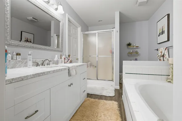 a en suite bathroom with a sink double vanity and tub