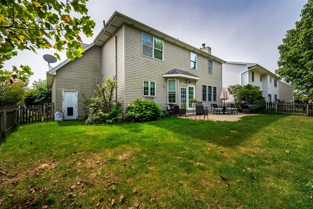 a front view of house with yard and green space