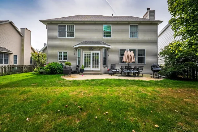 a front view of house with yard and outdoor seating