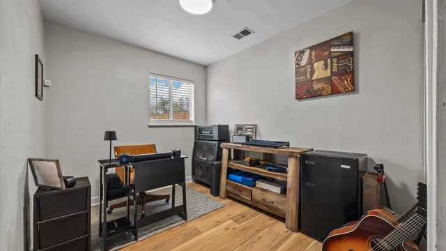 a view of a workspace with furniture and a window