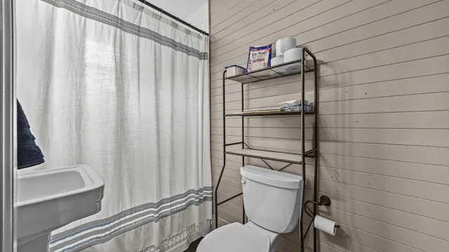 a bathroom with a toilet and a shower