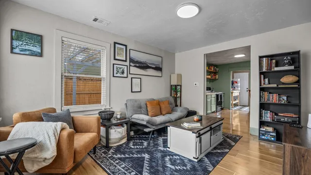 a living room with furniture a rug and a large window