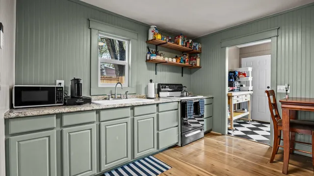 a kitchen with stainless steel appliances granite countertop a stove and cabinets