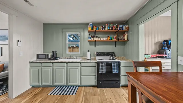 a kitchen with stainless steel appliances a sink and a stove