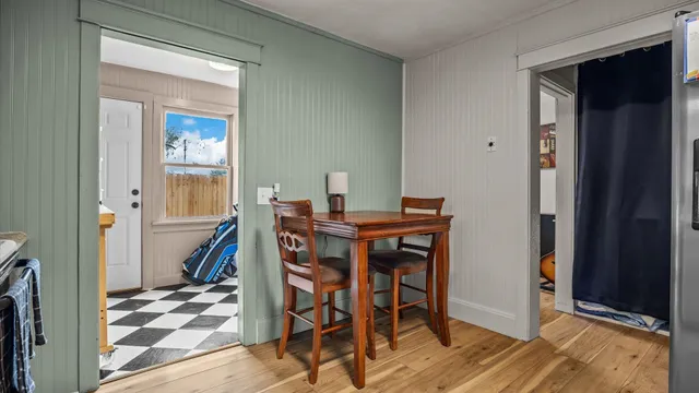 a dining room with furniture and wooden floor