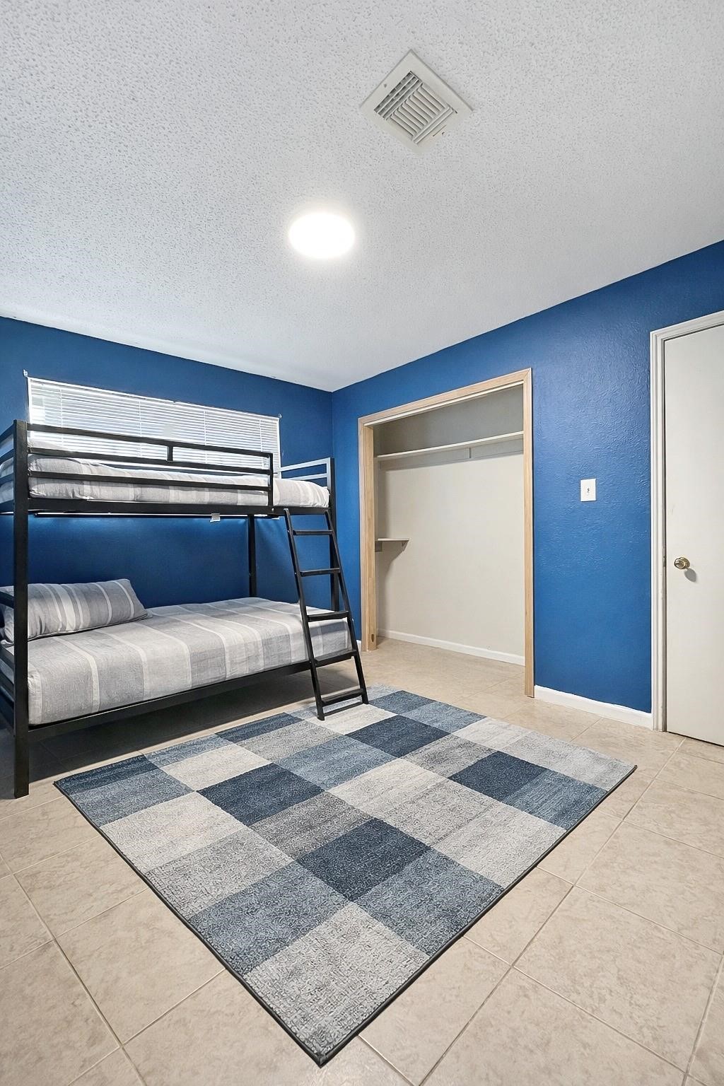 16230 Katherine Lane Channelview, TX 77530 - Photo 13 of 18 a bedroom with a bed and a dresser