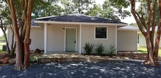 a front view of a house with garden