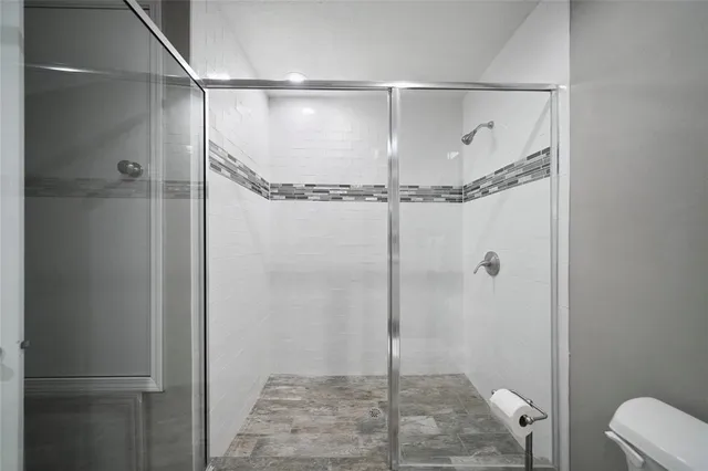 a bathroom with a glass shower door