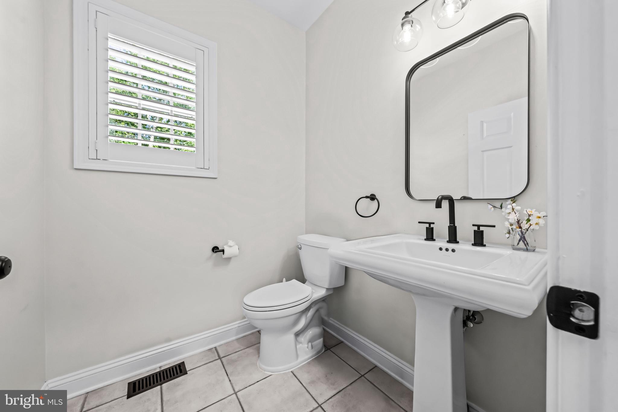 22 Tara Drive Sewell, NJ 08080 - Photo 30 of 70 a bathroom with a sink a toilet and mirror