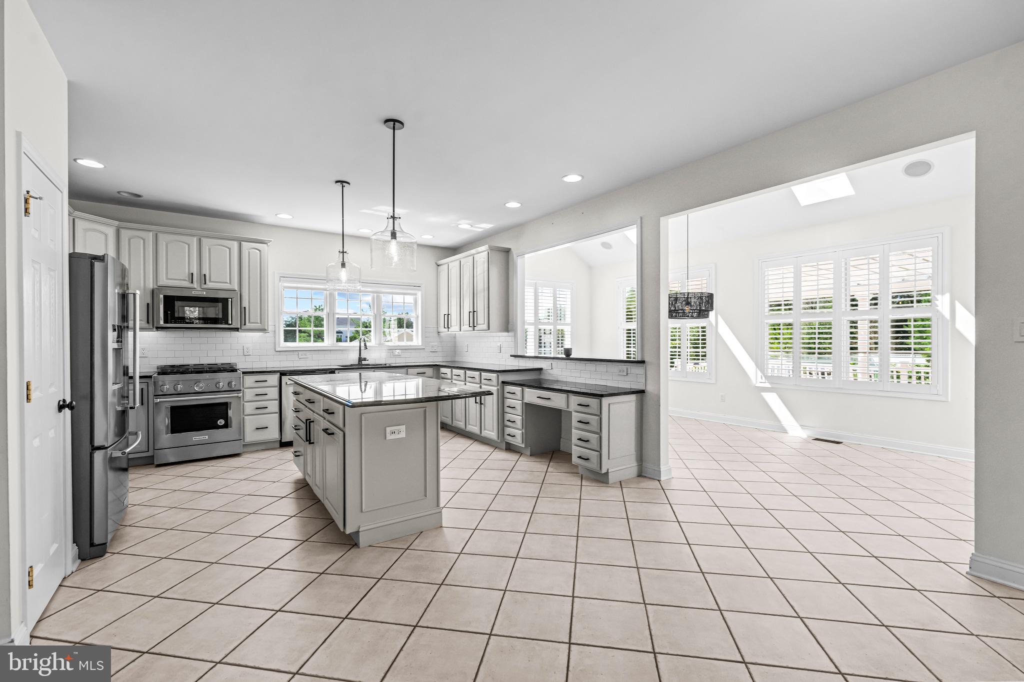 22 Tara Drive Sewell, NJ 08080 - Photo 37 of 70 a kitchen with stainless steel appliances granite countertop a stove a sink a microwave and a refrigerator